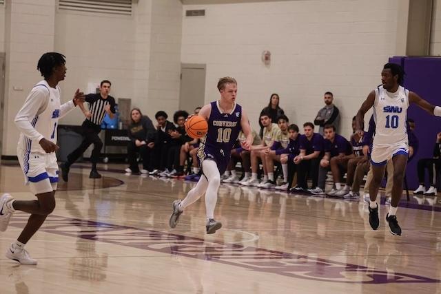 Will Fowler drives to the hoop in DII men's basketball. 