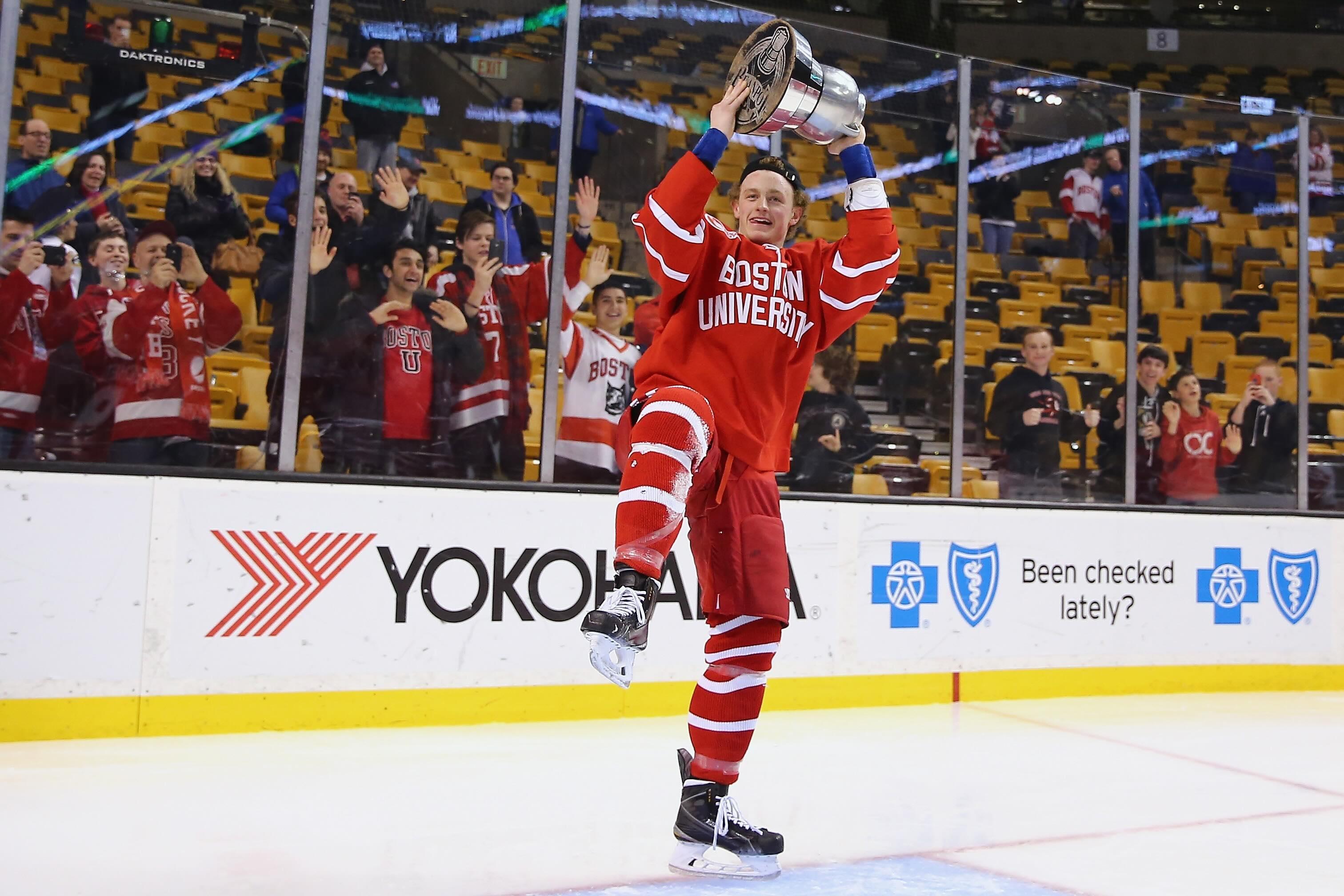 Boston University's Jack Eichel hoists the Beanpot in 2015